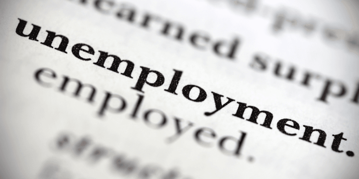Close-up of the word "unemployment" highlighted in dictionary text