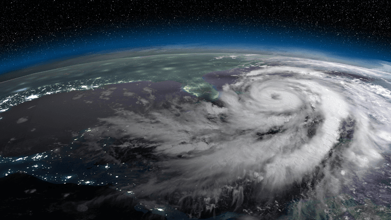 Satellite view of a powerful hurricane swirling over the Gulf of Mexico at night